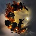 Halloween crescent moon wreath with black cat, orange flowers, and warm LED lights - Glowing Orange Flowers & Black Roses