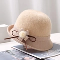 Detail of beige knit bucket hat featuring decorative flower, plush pompom, and leather strap - Flower / Beige