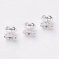 Macro detail of three silver hollow metal earring backs on white textured background - Silver (Color Retention)