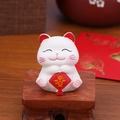 Miniature white fortune cat car ornament holding a red safety tag on wooden stand - XY005C Mini Peace Lucky Cat Ornament
