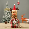 Close-up of reindeer plush embroidery and red green plaid fabric on Christmas gift bag - Plaid Reindeer