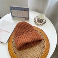 Thick knit orange-brown beanie hat with a wide rolled cuff in a cozy lifestyle setting - M(56-58cm) / Pumpkin Orange