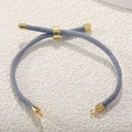 Close-up of grey Milan cord bracelet with adjustable gold-plated slider clasp and metal ends - Gray