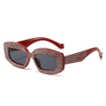Sparkly red cat eye sunglasses with silver rhinestones and dark grey lenses in 45-degree view - Red Frame Dark Grey Lens