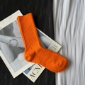 Vibrant orange ribbed calf socks on magazine background with high-quality knit texture - Short Vitality Orange