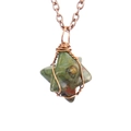 Macro shot of handmade wire-wrapped hexagram pendant featuring natural unakite stone - Antique Copper + Unakite