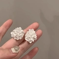 Detailed macro view of white layered petal flower earrings held in hand for scale - 9# Silver Earring Post - White Matte 3D Petal