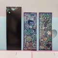 Detail of dark anime zombie stickers with glowing green outlines on grid paper - Little Zombie