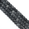 Macro detail of dark grey cracked glass round beads for DIY jewelry and accessory making - Black Floral Round Bead