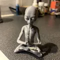 Close-up of a grey meditating alien resin figurine with visible 3D printed textures - Meditating Alien