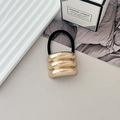 Golden textured geometric elastic hair tie with three-layer metal accent on white tray - Style A KC Gold