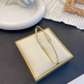 Elegant gold-plated knot bracelet featuring sparkling micro-pave cubic zirconia settings - Geometric Hoof Link Bangle / Gold