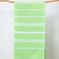 Light green Turkish beach towel with white stripes hanging on a wooden hanger - Fruit Green