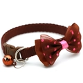 Brown pet collar with pink polka dot mesh bow and orange bell on white background - Coffee