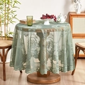 Green French lace tablecloth with ruffles on a round table in a rustic home setting - New Green Round Mirror Flower