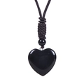 Detailed close-up of heart-shaped black obsidian pendant with adjustable woven cord - Obsidian