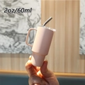 Close-up of 2oz 60ml pink stainless steel espresso cup with handle and straw - 2oz/60ml / Light Pink