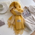 Soft yellow and beige cashmere-like tassel scarf with woven brand label on white surface - Bright Yellow