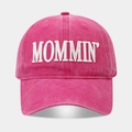 Close-up of MOMMIN embroidered text on washed cotton pink baseball cap with premium stitching - Rose Red