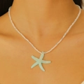 Y2K summer necklace with light blue starfish pendant and white beaded chain on model - Blue Starfish (KA-944)