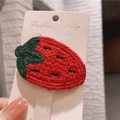 Handmade crochet strawberry hair clip with red and green yarn on display card - Strawberry