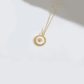 Chic gold necklace featuring a round white mother-of-pearl pendant with a gold star - Pentagram