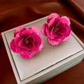 Close-up of pink 3D rose earrings with glossy petals on a beige jewelry cushion - Pink Flower (Silver Needle)