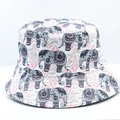 Close-up of elephant print and pink geometric patterns on a white reversible bucket hat - 21# White Elephant Ethnic Print