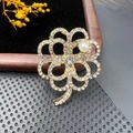 Macro detail of a vintage clover brooch featuring sparkling rhinestones and a white pearl - BZ013 Four-leaf Clover
