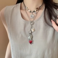 Close-up of layered necklace set featuring a red heart pendant and silver flower charm - Silver Coffee Heart Set Style (17#)
