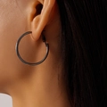 Close-up of black metallic geometric hoop earrings worn with sleek polished finish - 3cm / Gunmetal