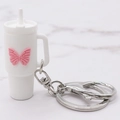 Mini matte white tumbler keychain featuring a 3D pink butterfly and silver metal ring - White Butterfly Cup Keychain