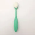 Oval foundation brush with mint green handle and dense white synthetic bristles - Jade Color