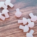 Pink mushroom-shaped soft silicone earplugs set scattered on a wooden surface - Rose Quartz