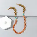 Detail view of colorful acrylic glasses chain with amber and orange geometric links - Orange