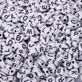 Close-up of heart-shaped acrylic alphabet beads with black letters for DIY jewelry making - Heart Shape White Black Letters (100pcs)