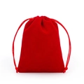 Macro view of bright red drawstring velvet pouch for jewelry storage on white background - Red