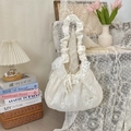 Macro detail of white lace shoulder bag with floral embroidery and ruffled strap design - Chiffon Petal Beige