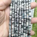Macro detail of natural black and white marble heishi spacer beads for DIY jewelry making - Black Network Stone