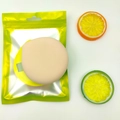 Round beige XL cushion puff in a yellow pouch with fresh lemon slice decorations - Marshmallow Yellow (XL) Bagged