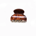 Detail view of a small leopard print acetate claw clip with amber resin texture - Coffee