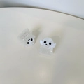 Detail of small white marble ghost hair claws with cute faces in minimalist setting - Ghost