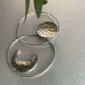 Detailed close-up of asymmetric silver moon and sun drop earrings with hammered texture finish - Asymmetric Sun & Moon / Silver