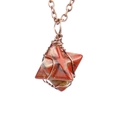 Macro shot of hand-wrapped red jasper merkaba star pendant with antique bronze wire detail - Antique Copper + Red Jasper