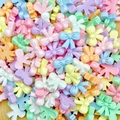 Macro shot of colorful mini resin bow charms in various candy colors for nail art and jewelry - Ribbon Bow