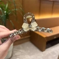 Detail of champagne gold hair claw clip featuring crystal bow design and secure metal spring - Full Rhinestone Bow Decoration / 11cm / Champagne