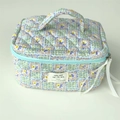 Quilted floral makeup bag in light blue and purple with top handle and ribbon zipper - Green Plaid Floral