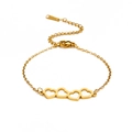 Elegante bracciale in acciaio al titanio dorato con quattro ciondoli a cuore e catena regolabile - Oro