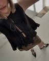 Detail of a black pleated sleeveless top with bow ties and a brown cotton mini skirt - Black Top