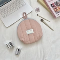 Detailed flat lay of a pink quilted shell makeup bag with blue zipper and handle - Nude Pink